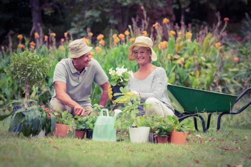 Gardener working in a Notting Hill garden with tools and plants